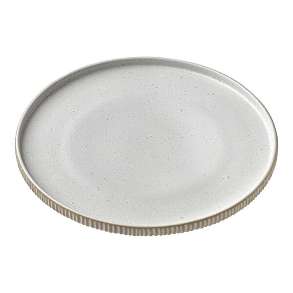 A close-up of a Playground Nara white high rim plate with a white rim.