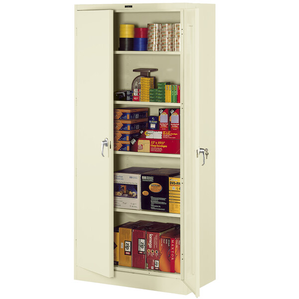 A putty Tennsco storage cabinet with shelves and boxes inside.