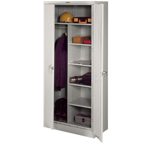 A light grey Tennsco combination cabinet with solid doors and shelves holding objects.