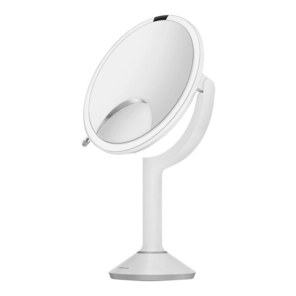A white circular mirror with a white stand.