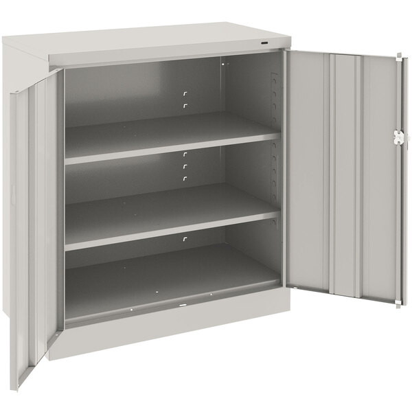 A light gray metal storage cabinet with open doors.