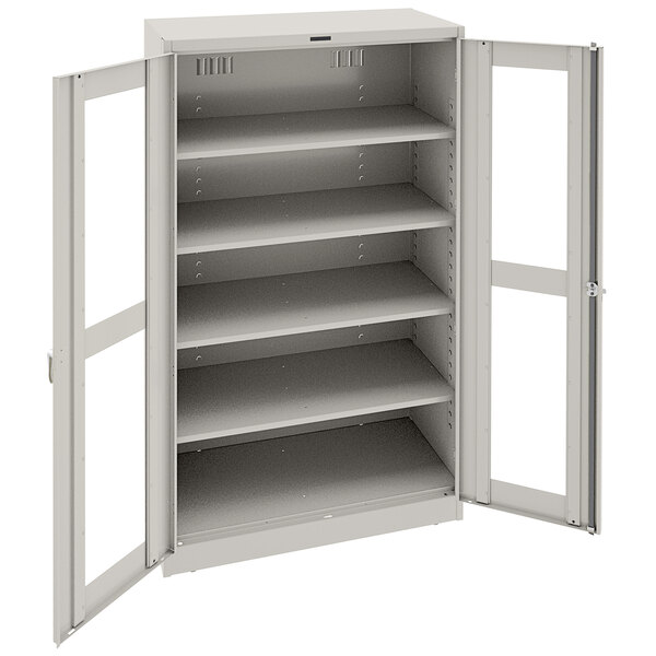 A light gray metal Tennsco storage cabinet with open doors.