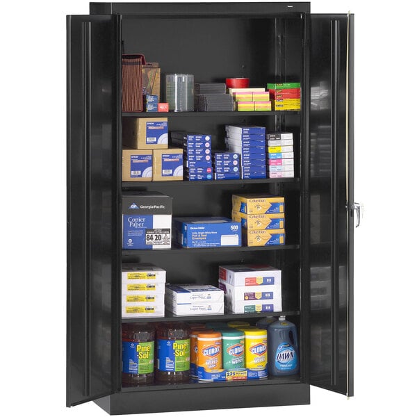 A black metal Tennsco storage cabinet with shelves full of boxes and other items.