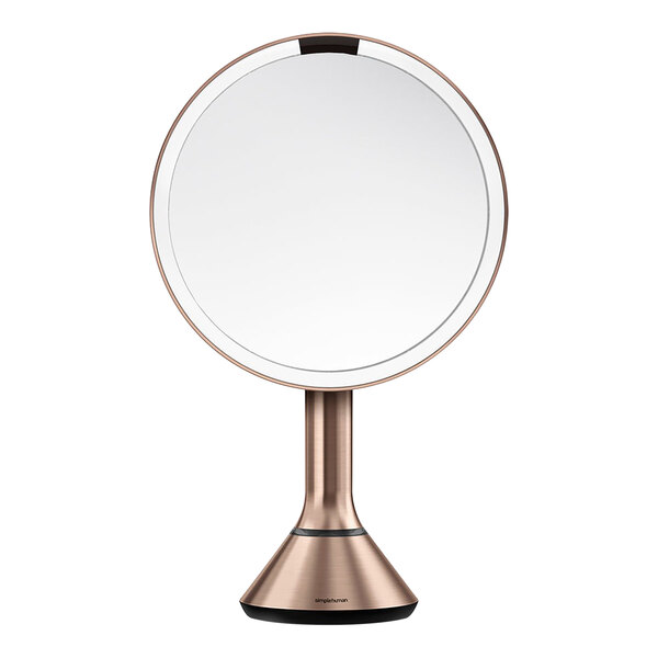 A simplehuman round mirror with a rose gold metal stand.