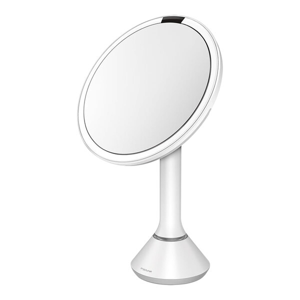 A round white stainless steel sensor mirror with a stand.