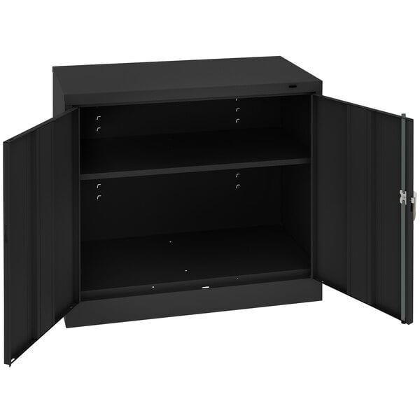 A black Tennsco metal storage cabinet with open doors.