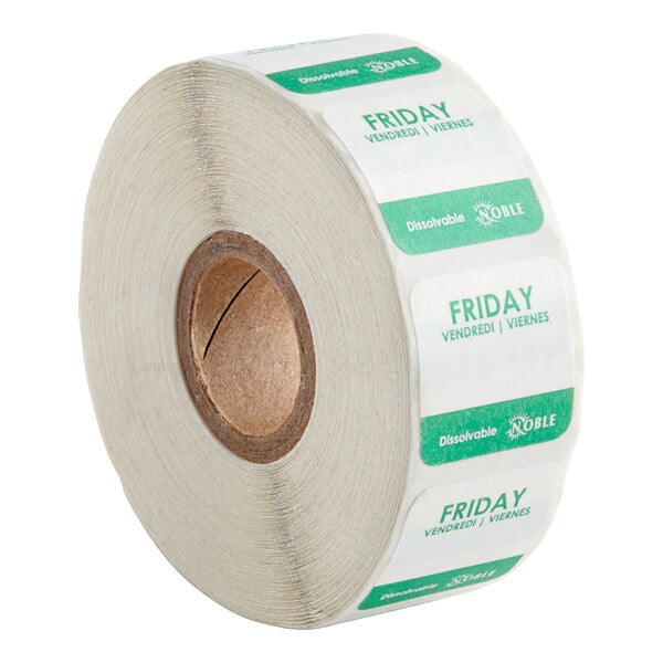 A roll of white labels with green and white text for each day of the week, including Friday.