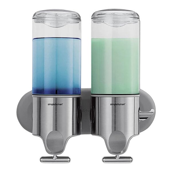A simplehuman stainless steel double soap dispenser on a wall with blue and silver pumps.