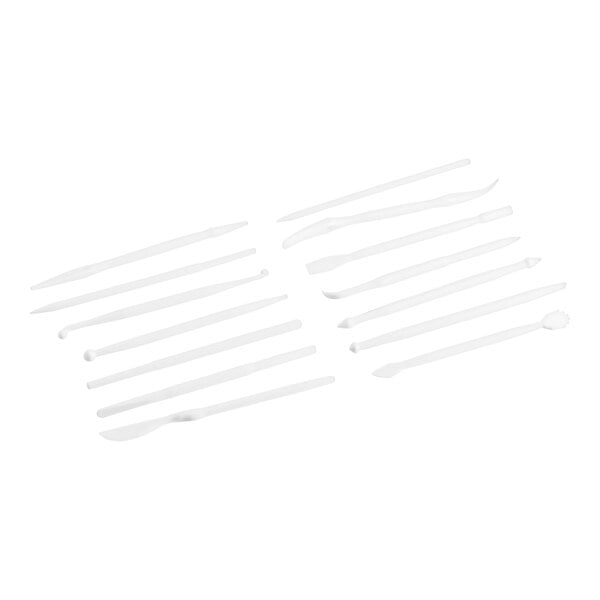 A group of white plastic tools including spoons.