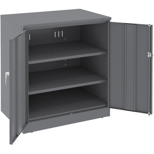 A dark gray Tennsco steel storage cabinet with open doors.