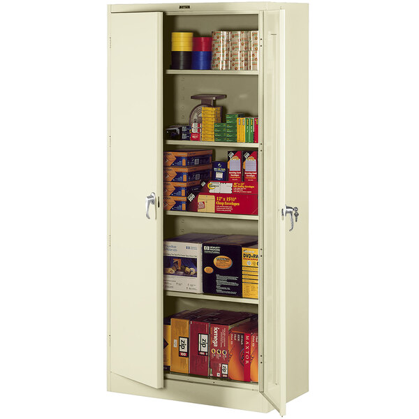 A metal Tennsco storage cabinet with shelves full of items.