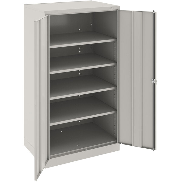 A light gray metal Tennsco storage cabinet with solid doors.