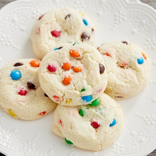 A plate of cookies with M&M's Milk Chocolate Mini Baking Bits on them.