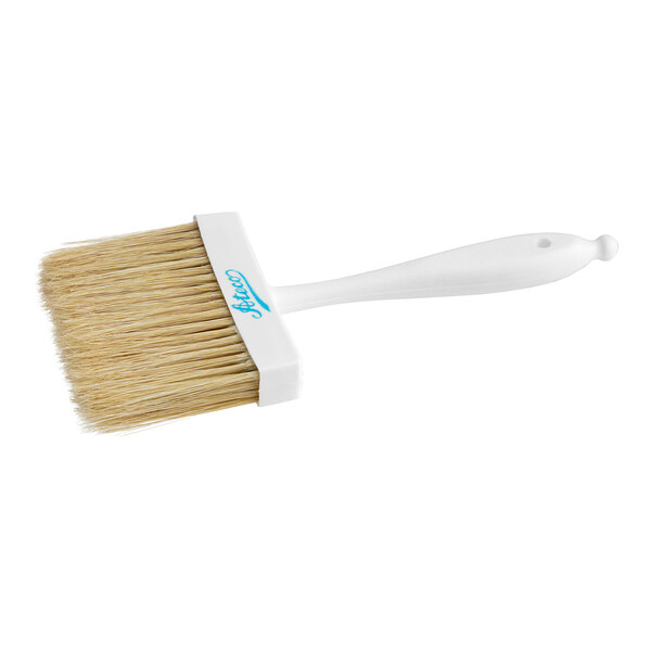 An Ateco white pastry brush with a plastic handle.