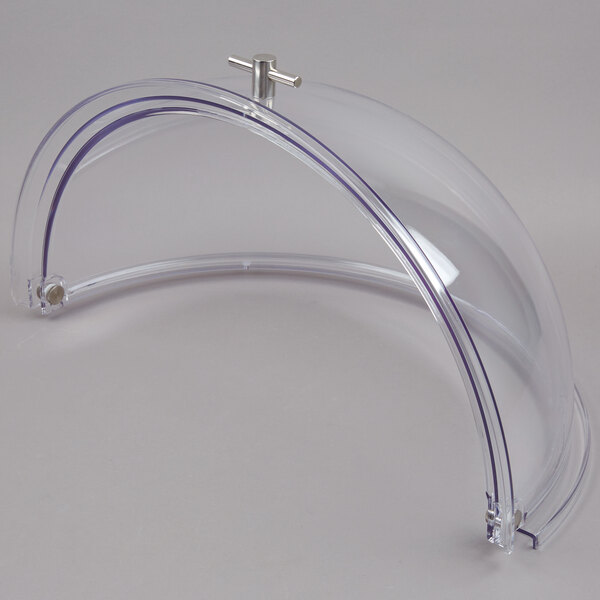 A clear plastic round lid with a metal handle.