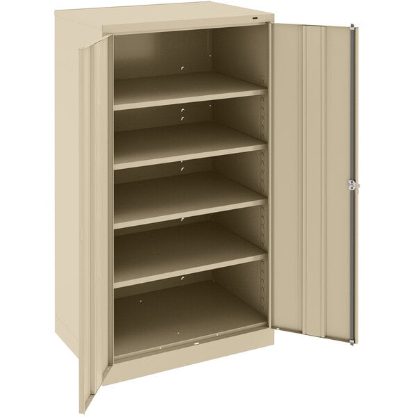 A tan metal Tennsco storage cabinet with open doors.