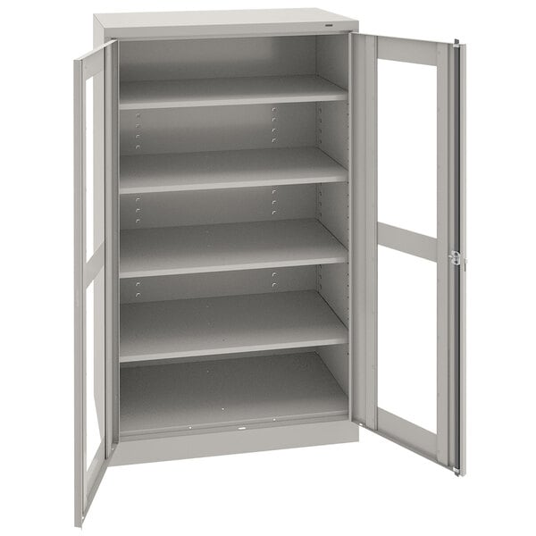 A light gray metal Tennsco storage cabinet with open doors.