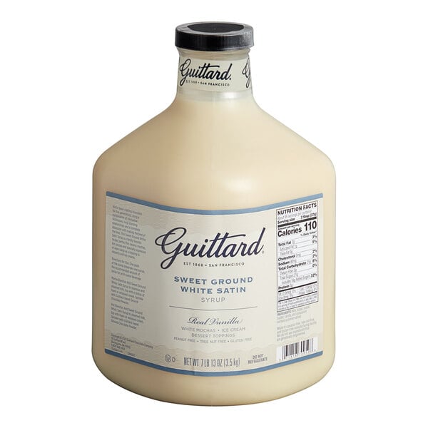 A bottle of Guittard Sweet Ground White Satin Chocolate Flavoring Sauce with a white label containing white liquid.