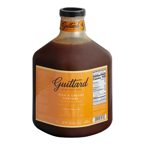 A bottle of Guittard Rich and Creamy Caramel Flavoring Sauce with a label.