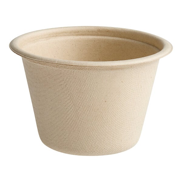 A small, natural-colored compostable portion cup made from plant fiber.