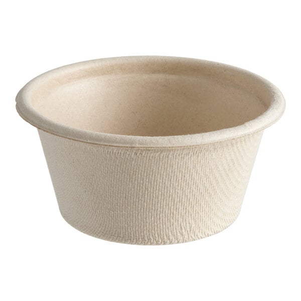 A small, natural-colored compostable portion cup made from plant fiber.