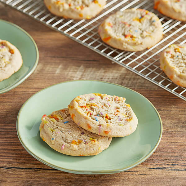 A plate of Root Nine Baking Co. birthday cake cookies with sprinkles on them.