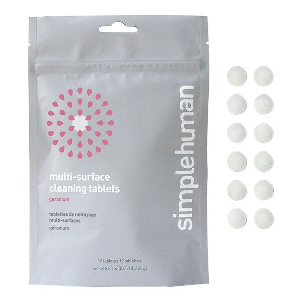 A white plastic bag with a pink and white simplehuman logo containing round white simplehuman multi-surface cleaning tablets.