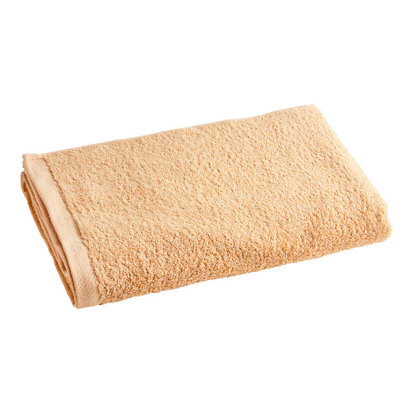 A close-up of a beige Oxford Zinnia pool towel.