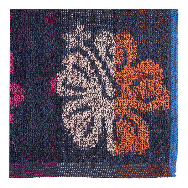 A close-up of a blue and pink jacquard fabric with a flower pattern.