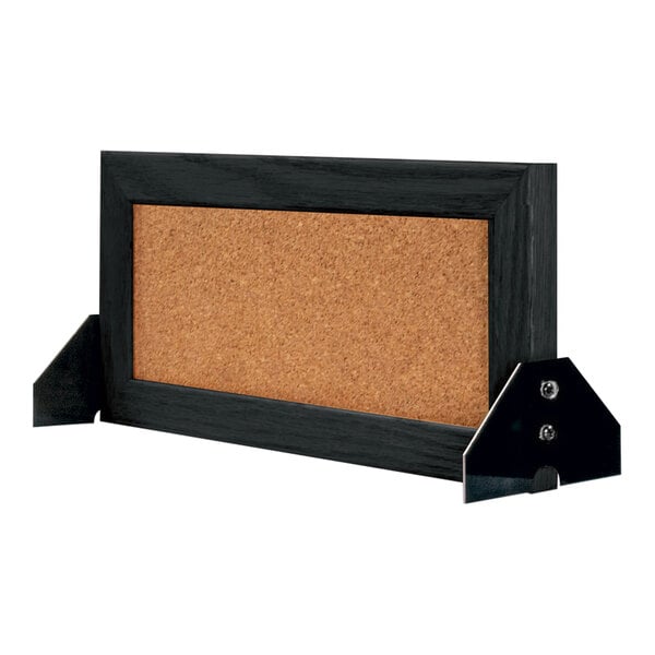 A cork board with a black wood frame.
