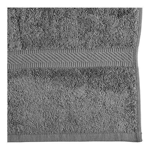 A close-up of an Oxford Imperiale charcoal gray pool towel with a stripe.