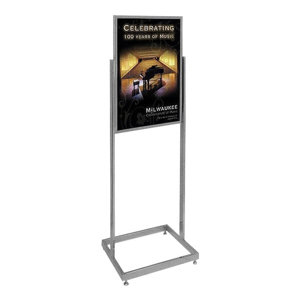A United Visual Products chrome steel pedestal sign stand with a poster on it.
