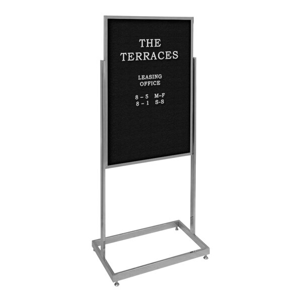 A United Visual Products black pedestal letterboard sign with white text on it.