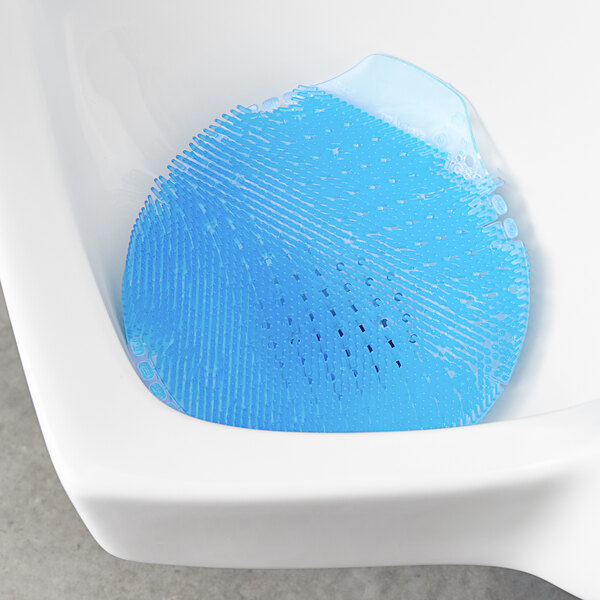 A blue urinal screen with small holes in a blue circle.