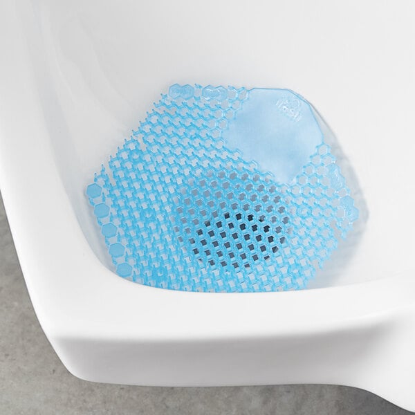 A blue mesh mat with Fresh Products Wave 3D Cotton Blossom Scent design in a urinal.