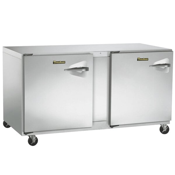 A Traulsen undercounter freezer with left hinged doors and a stainless steel back.