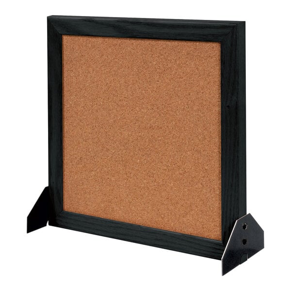 A cork board with a black wood frame.