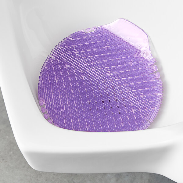 A purple round urinal screen with small dots.