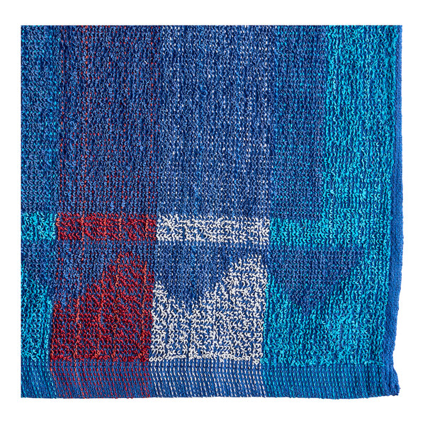 A blue and red jacquard pool towel with white and red squares.