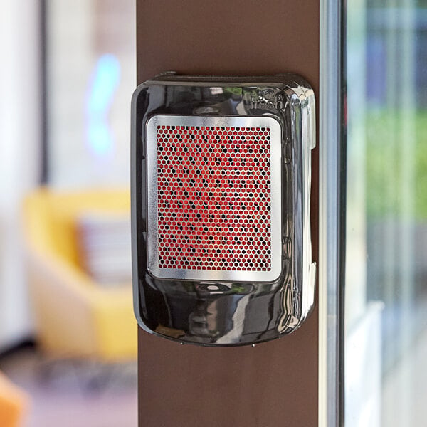 A black air freshener cabinet with red accents on the grill.