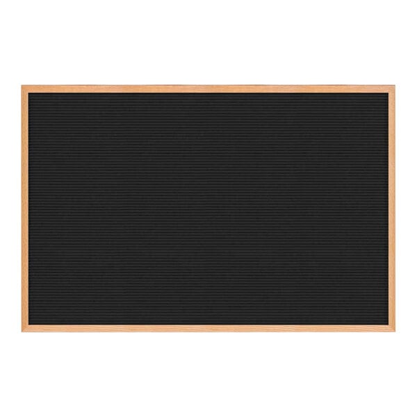 A black countertop letterboard with a light oak wood frame.