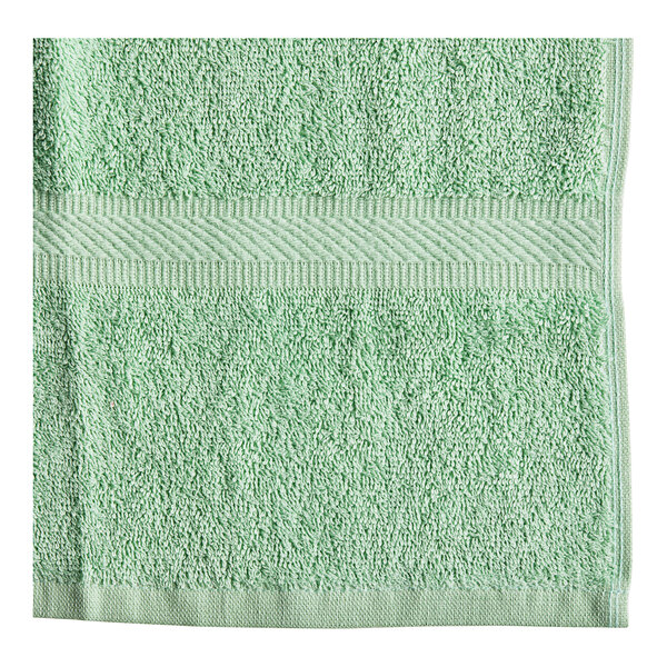 A close up of a green Oxford Imperiale pool towel.