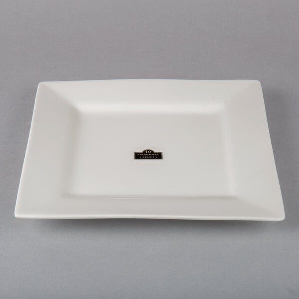 A white square porcelain plate with a black square logo on it.