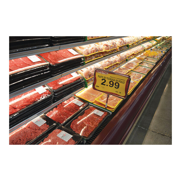 Black ABS meat shelf liners on a grocery store meat display.