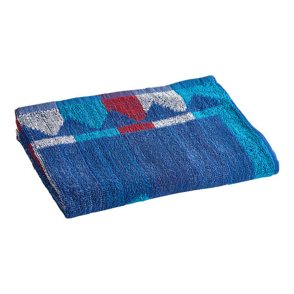 An Oxford blue pool towel with a red and white geometric design.