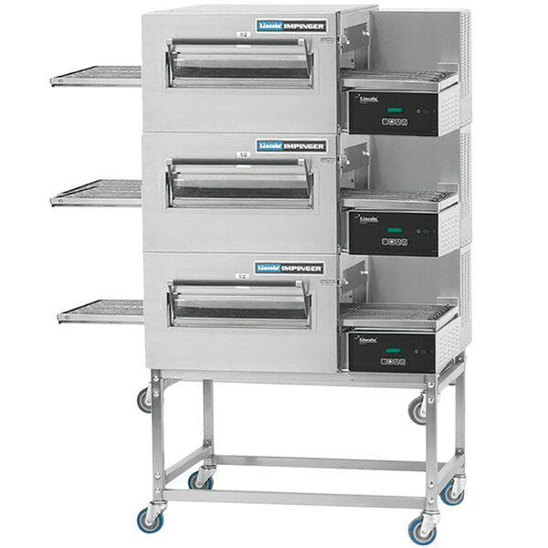 A stainless steel three tier Lincoln Impinger conveyor oven rack with three ovens on it.