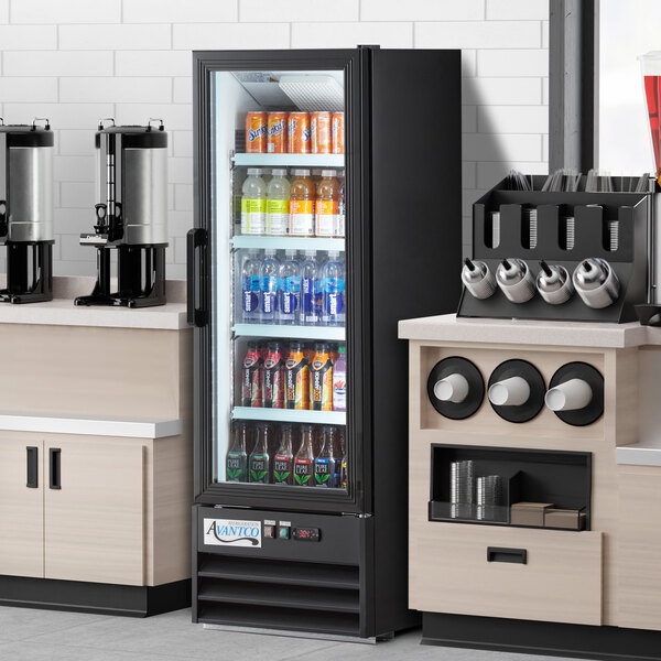 An Avantco black merchandising refrigerator full of beverages.