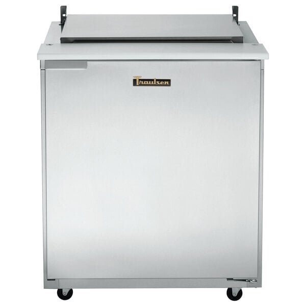 A stainless steel Traulsen refrigerated sandwich prep table with a white rectangular lid.