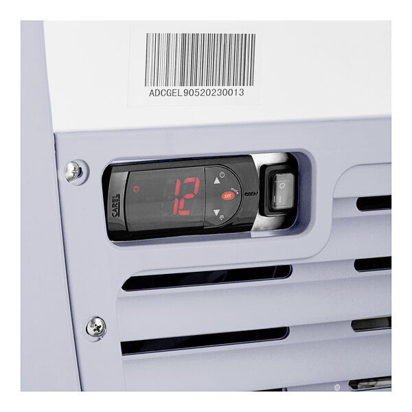 An Avantco gelato dipping cabinet with a curved sneeze guard and pans.