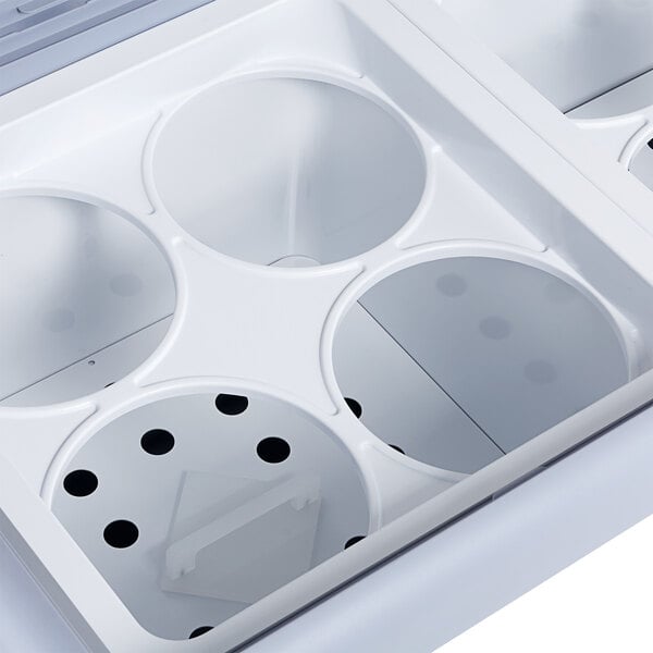 An Avantco white ice cream dipping cabinet with four compartments and two holes in the front.